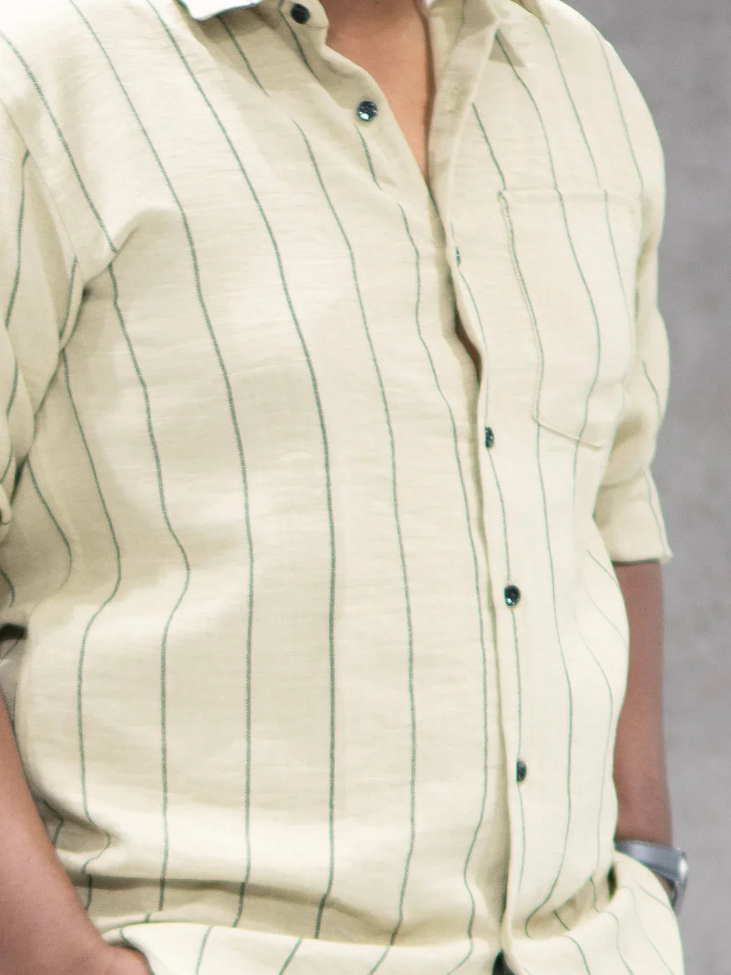 Cream striped men's button-down shirt with green vertical lines, ideal for office or smart casual wear