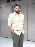 Man in striped button-down shirt and tailored pants for modern office wear