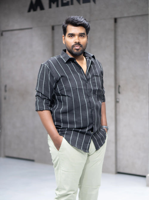 Man in charcoal striped shirt and light chinos, modern office style for everyday wear